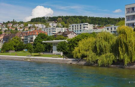 Zurich, Switzerland - May 27, 2019: buildings of the city of Zurich along the Limmat river. Zurich is the largest city in Switzerland and the capital of the Swiss canton of Zurich.のeditorial素材