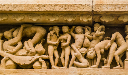 Stone carved erotic sculpture in Khajuraho temple, Indiaの写真素材
