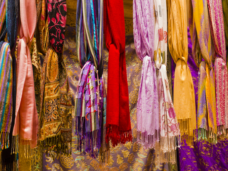 Row of colorful silk scarvers hanging on market stall, Indiaの写真素材