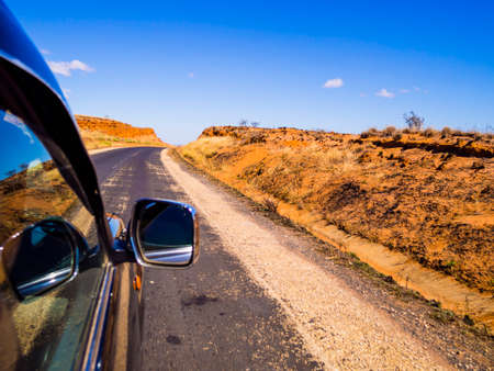 Driving a car on scenic Route Nationale 7 (RN7) through the savannah of Madagascar highlandsの写真素材