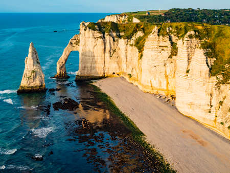 Panoramic view of Etretat coastline, vertical chalk cliffs with impressive arch and pinnacle, Normandy, Franceの写真素材