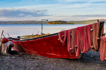Typical fishermen boat docked on Marta beach, a little medieval village on Bolsena lakeshore,...