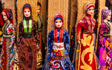 Showcase of souvenir dolls dressed in traditional turkish clothing, featuring richly decorated fabrics, vibrant colors and intricate embroideryの写真素材