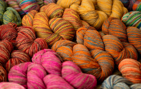 Set of colorful wool yarn balls. Hanks are set out in a pile.