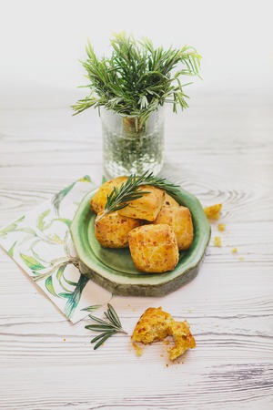 Scone with carrot is a traditional English pastry for afternoon tea or coffee breaks. Delicious buns are ready for maintenance on a wooden table. Scones with macro conceptの写真素材