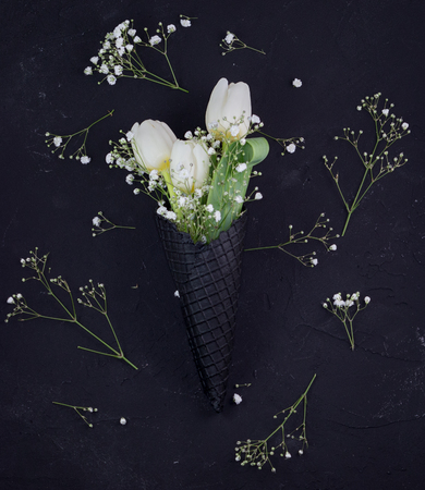 A bouquet of white tulips on a black background. Closeup.の写真素材