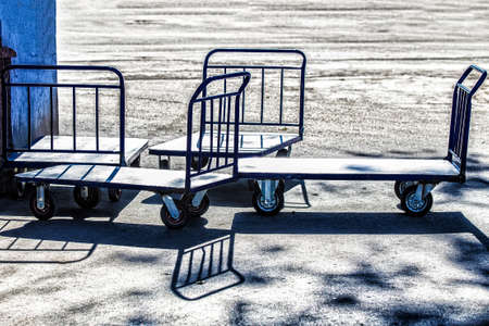 Several transportation trolleys stand on asphalt. Summer sunny dayの写真素材