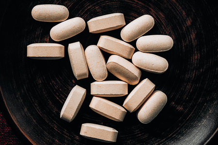 Vitamin C pills on a black plate. Close-up.の写真素材