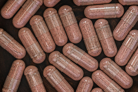 Capsules of medicine on a wooden background. Top view.の写真素材