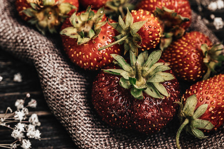 Strawberries on rustic wooden background. Strawberries on sackcloth.の写真素材