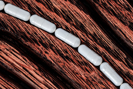 Close-up of white pills on a wooden background with copy spaceの写真素材