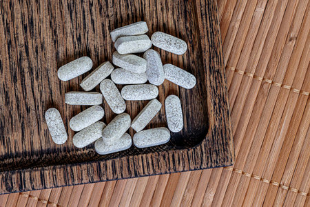 Pills on a wooden table. Tablets on a wooden background.
