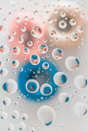 Water drops on glass. Abstract background with colorful circles. Macro shotの写真素材