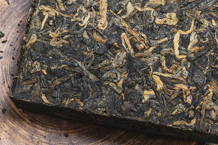 selective focus photo of a tile of palace puerh tea. chinese pressed black loose leaf tea shu puerh.の写真素材