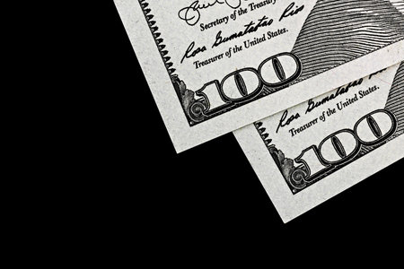 topview of fragment of dollar bills on black velvet, as a backgroundの写真素材