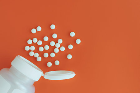 topview of methyl folate tablets flying from the jar. dietary concept. dietary supplement close-up