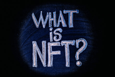 Photo on NFT (non-fungible token) theme. The question What is NFT?, in the center of the light...