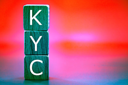 photo on know your customer (KYC) guidelines in financial services theme. wooden cubes with the abbreviation "KYC", against the background like the northern lightsの写真素材