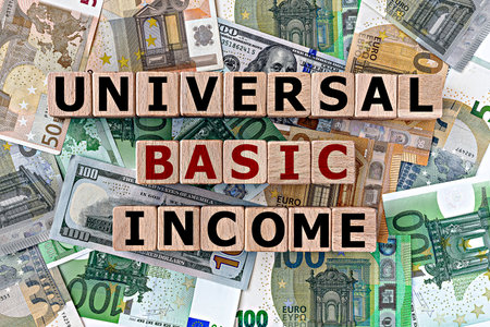 topview photo on universal basic income theme. wooden cubes with the inscription "universal basic income", on the background of dollar and euro billsの写真素材