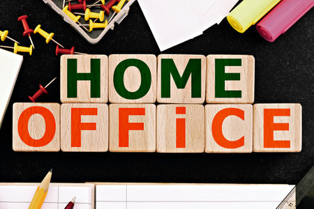 photo on home office theme. wooden cubes with the inscription "home office", surrounded by office supplies. business concept imageの写真素材