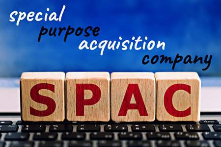 photo on spac (special purpose acquisition company) theme. wooden cubes with the abbreviation "spac", and the inscription "special purpose acquisition company", on blue background. business concept imageの写真素材