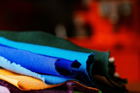 selective focus photo of multicolored fabric samples. serigraphy production. printing images on clothes in a design studioの写真素材