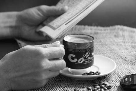 coffee while reading newspaper black and whiteの写真素材