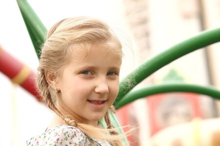 portrait of blond girl smiling outside autumn dayの写真素材