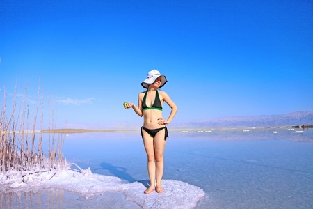 girl sunbathing on the beach with warm summer dayの写真素材