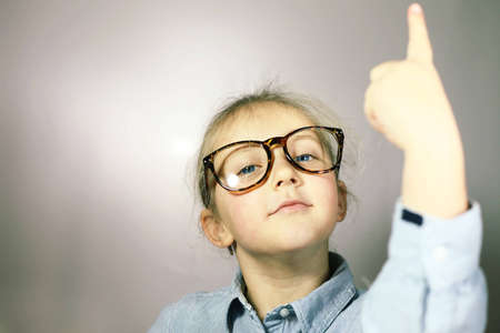 schoolgirl with big glasses blonde with blue eyesの写真素材