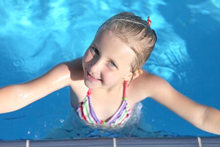 girl in swimming pool summer dayの写真素材