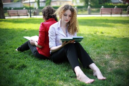 student learning in the park on the grassの写真素材