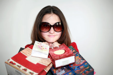 a girl in glasses after shopping isolated