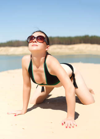 Brunette enjoying the sun on the beachの写真素材