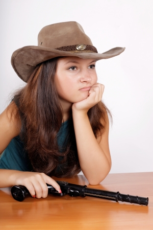 cowgirl a hat with a gunの写真素材