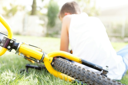 Boy with bike outdoors in summer dayの写真素材