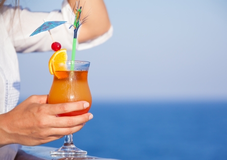 citrus cold cocktail in hand girlsの写真素材