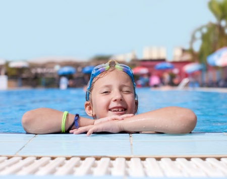 the girl is resting after a swim in the poolの写真素材