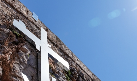 steel cross on the rock, summer dayの写真素材
