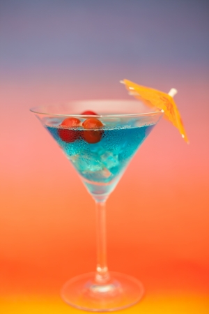 Blue cold cocktail with berries on a colorful backgroundの写真素材