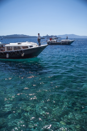 SANTORINI / GREECE - 3 JULY 2012: Pleasure boats on the sea, collect customers for relaxing, walking on the sea 3 july 2012 Santorini.のeditorial素材