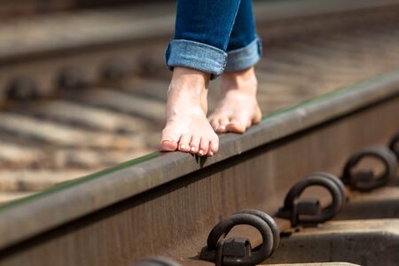feet are on the railroad close-up summer dayの写真素材