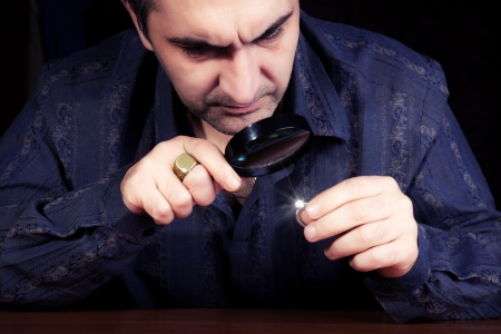 portrait of a jeweler during the evaluation of jewelsの写真素材