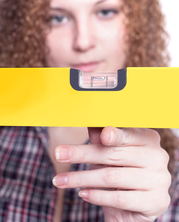 the girl with the level looking for the best solutionの写真素材