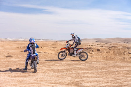 racing motorcycles on the desert terrain, summer day