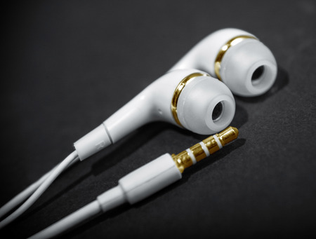 white headphones close up dark backgroundの写真素材