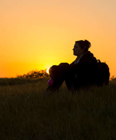 girl enjoying nature at sunset in natureの写真素材