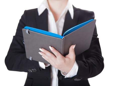 businesswoman a notebook, isolated white の写真素材