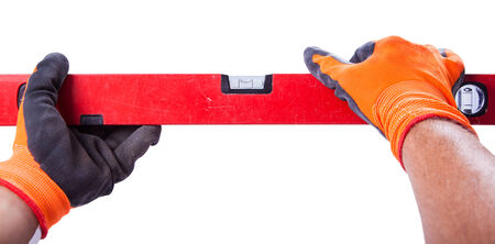  male hands hold a level on a white background isolatedの写真素材