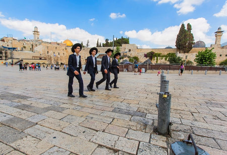 JERUSALEM/ISRAEL - 20 SEPTEMBER 2014: four young Jews walking in the street of Old Jerusalem. 20...